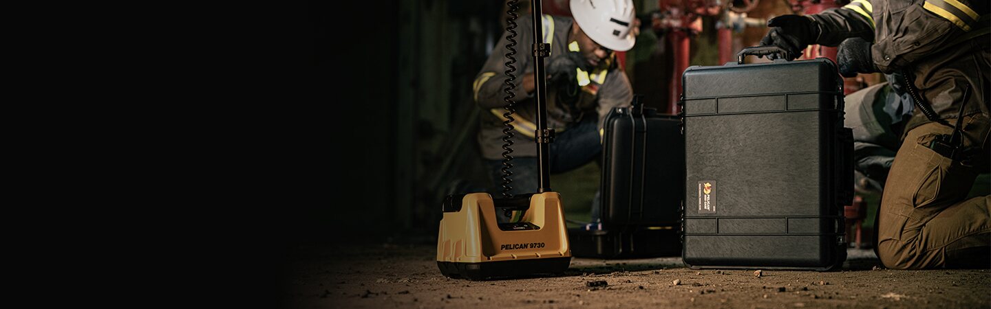 Pelican Protector case beside industrial lighting equipment